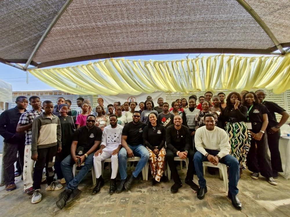 Large group photograph of facilitators and participants after the outdoor session