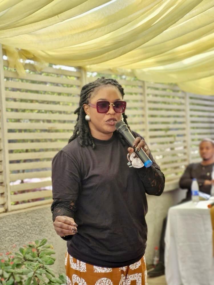 A co-facilitator addressing participants at the outdoor session
