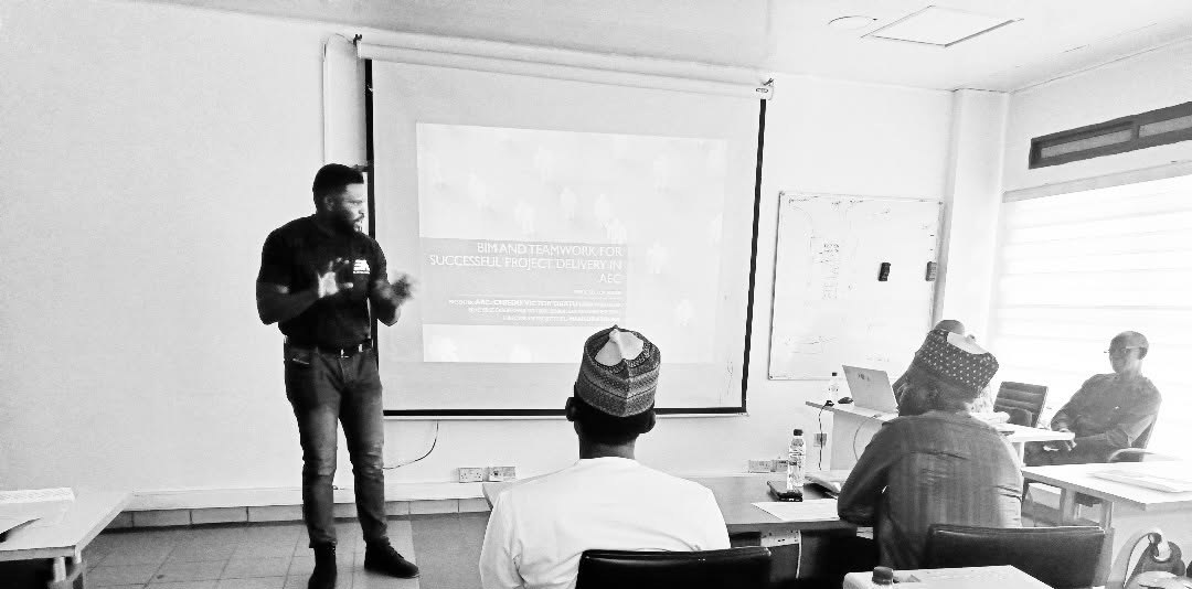 Victor presenting a training session to a seated professional audience in Abuja